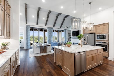 Kitchen with a notable chandelier, light stone co