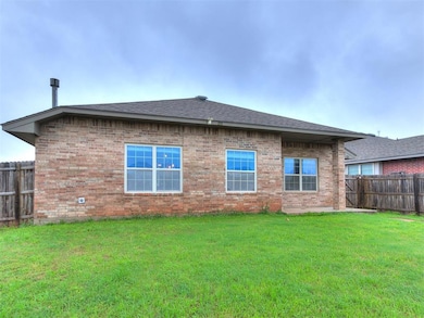 Rear view of property with brick siding and a shingled roof