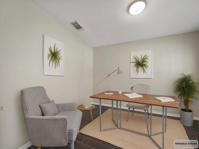 Virtually Staged. A private home office sits near the entry, offering the perfect quiet space to focus or relax with morning coffee.