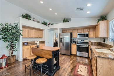 Kitchen with stainless steel appliances, a sink, l