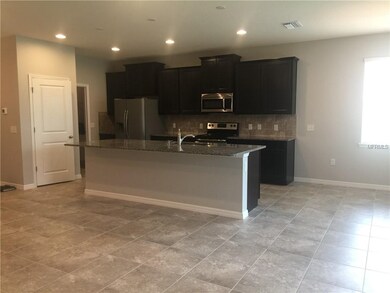 Kitchen with laundry in hall leading to the 2 car 