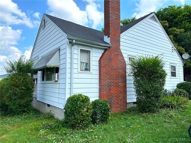 View of side of property featuring a yard