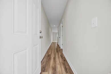 Hall with hardwood / wood-style flooring