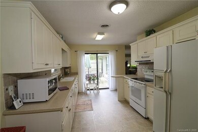 Enter from the carport through the kitchen door or