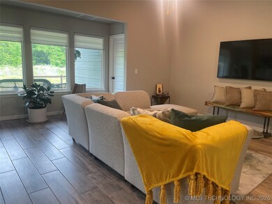 Living room featuring dark wood-type flooring and baseboards