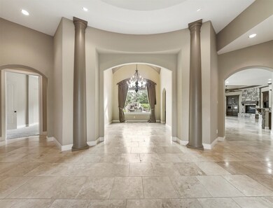 View from the front door through the dining room to the back yard pool is amazing. Beautiful arch doorway and art niches.
