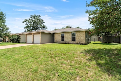 Ranch-style home with a garage, concrete driveway