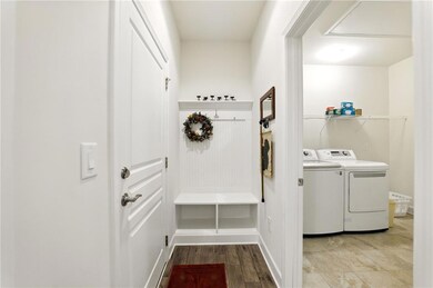 Mudroom featuring washing machine and dryer and wo