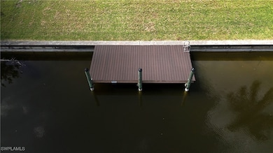 Dock featuring a water view and a yard