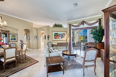 Living area with ornamental molding and light tile