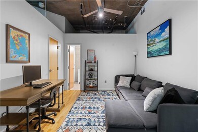 Office space with a towering ceiling and light wood-style floors