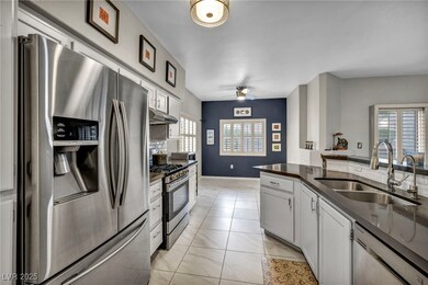 Kitchen featuring stainless steel appliances, a si