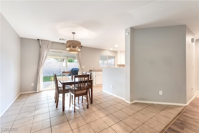 Dining room featuring light tile patterned flooring and recessed lighting