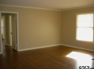 Big windows let in natural light.  Hallway on left leads to 3 bedroom and a bath