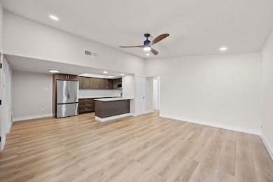 Unfurnished living room featuring recessed lighting, light wood-style floors, and a ceiling fan