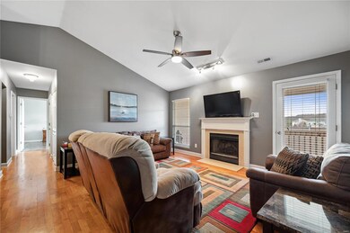 Living Room with hardwood flooring, wood-burning f