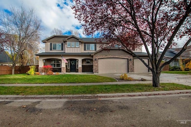 View of front of house with covered porch, driveway, a garage, and stone siding