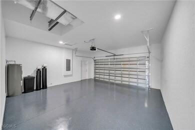 Garage featuring water heater, electric panel, and