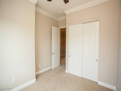 Unfurnished bedroom featuring light carpet, orname