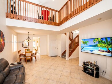 Large living area with elegant high ceilings.