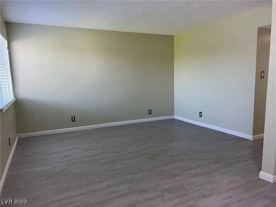 Unfurnished room featuring dark wood-style floorin