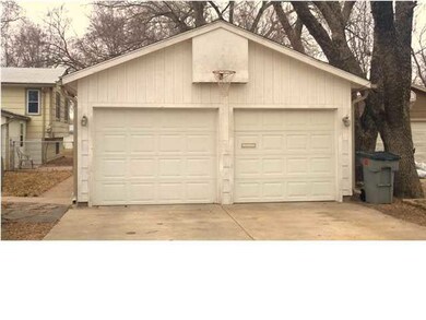 This oversized garage features an office and a sto