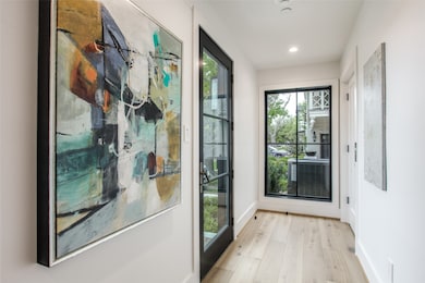 Doorway featuring wood finished floors and recessed lighting
