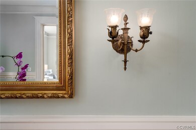 A pair of sconces in the entry hall, originally gas, but now electrified, are one of many original details intact in the home.