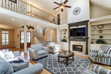 Vaulted great room provides gas fireplace, built-i