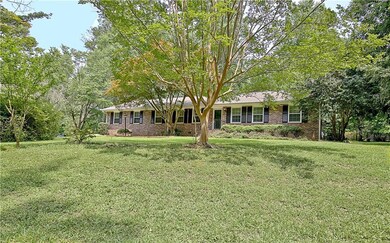 Single story home featuring a front lawn and brick siding