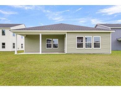 Rear view of house with a lawn