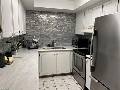 Kitchen with decorative backsplash, appliances wit