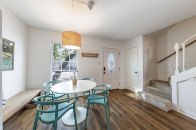 Dining area featuring dark wood-style floors and 