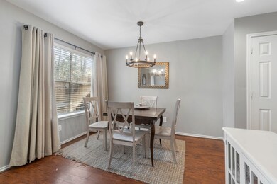 A charming breakfast nook sits adjacent to the kit
