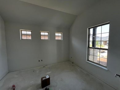 Spare room with plenty of natural light and vault