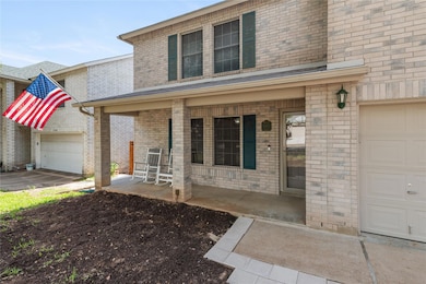 View of front of house with a garage, covered por