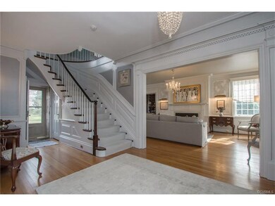 The central hall features a curved staircase to th