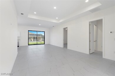 Empty room with a tray ceiling, marble finish floo