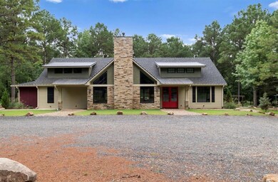 View of front of house featuring french doors, a chimney, roof with shingles, and view of scattered trees