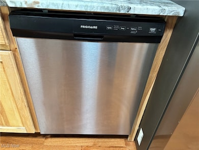 Kitchen view of stainless steel dishwasher