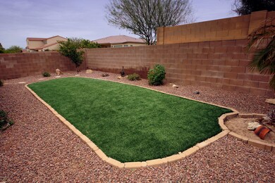 Backyard area with artificial grass.