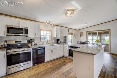 Kitchen featuring stainless steel appliances, crow