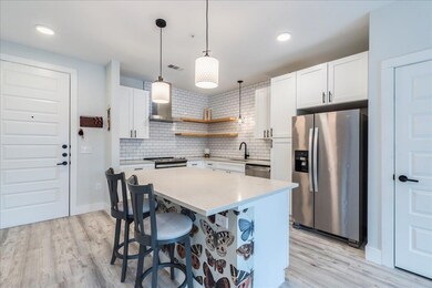 Kitchen featuring stainless steel appliances, ope
