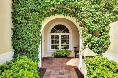 Entryway framed by vibrant, cascading bougainville