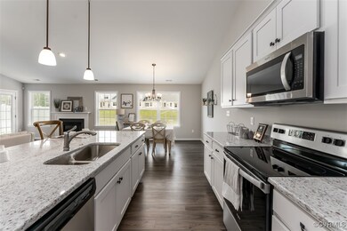Kitchen with light stone counters, stainless steel