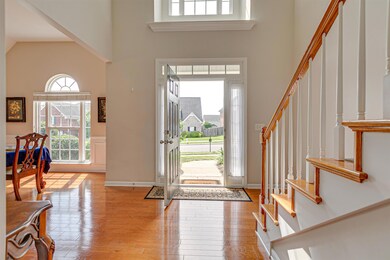 The entry foyer is dramatic with lots of natural light from the arched window and the high ceiling.  The hardwood floors give off a rich, warm glow here.