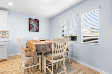 Dining area featuring baseboards and light wood-type flooring