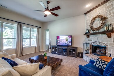 Living room with gas log fireplace, entrance to Primary bedroom