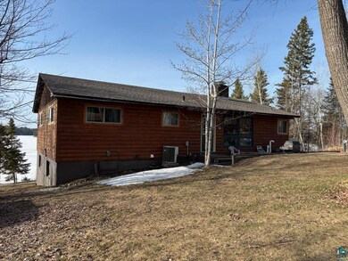 Back of property featuring cooling unit, a chimney, a lawn, a shingled roof, and a patio