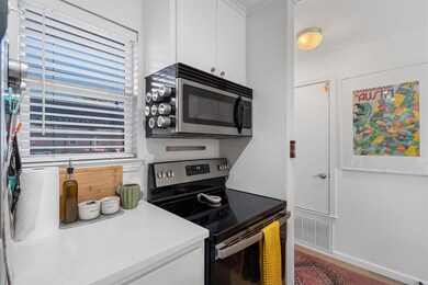 Kitchen featuring white cabinets, visible vents, 